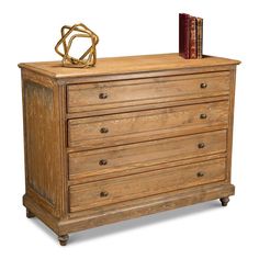 an old wooden dresser with books on top