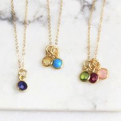 "These tiny crystal birthstone charms make a meaningful ultra dainty necklace.  Wear one to represent your little lovies, you and your other or your circle of friends.  Each necklace is truly one of a kind.   These ultra tiny sparkling CZ crystal charms make a meaningful gift for mom or a best friend.   It's minimal tiny design makes it the perfect everyday necklace too!  D E T A I L S -6mm dainty gemstone charms -Choose up to 6 charms.  -14kt Gold-Filled or sterling silver necklace  -A high quality delicate link chain with a spring clasp.  Please leave birthstone months in ORDER in the message box at checkout.   LENGTH *Please select from the drop down selection. *The standard length is normally 18\". *Model is wearing 16\" in Photos. HOW TO PERSONALIZE *Select your choices from the drop Tiny Round Pendant Charm Necklaces For Gift, Tiny Round Pendant Charm Necklaces As Gift, Gift Tiny Round Pendant Charm Necklaces, May Birthstone Charm Necklace For Mom With Round Pendant, May Birthstone Round Pendant Charm Necklace For Mom, May Birthstone Round Pendant Necklace For Mom, Dainty Birthstone Necklace With Charms, Dainty May Birthstone Necklace With Charms, Dainty Sterling Silver Birthstone Necklace For Mom