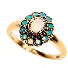 This gorgeous Vintage Inspired Flower Ring has been crafted from 9ct Solid Gold. A bezel set oval cut NATURAL Opal with surrounding NATURAL Opals brings this ring to life. Notice the stamens that surround the petals of this beautiful ring. This is an elegant Victorian inspired ring which simply looks beautiful on a lady who enjoys wearing fine jewellery from a Vintage era. THIS VINTAGE INSPIRED OPAL RING IS TRULY AN EXQUISITE FINE JEWELLERY PIECE WHICH IS TO BE TREASURED FOR A LIFETIME ! HOW TO Gold Opal Ring, Opal Ring, Natural Opal, Opal, Ring, Gold