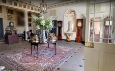 an ornate room with antique furniture and flowers in vases