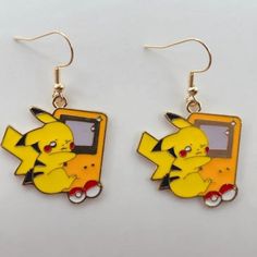 the pokemon pikachu and eebi earrings are on display in front of a white background