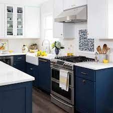 a kitchen with blue cabinets and white counter tops