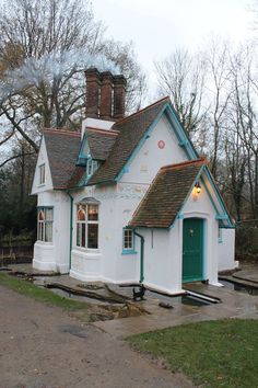 a small white house with a green door