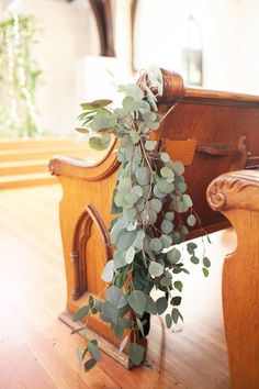 a bunch of green leaves sitting on top of a wooden bench