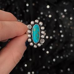 A single oval piece of American turquoise is the centerpiece of this statement ring. Centered with a large boarder of silver spheres, the stone is able to pop. Tiny star stamped details add an extra touch of magic. Patinated and polished, the back holds the Spell & Stone maker's mark. Size 7.5, can be sized up to a 8.5 if needed. ★ Handmade ★ .925 Sterling Silver ★ American Turquoise ★ Size 7.5 - Can Be Sized Up ★ Half Round Ring Band ★ 26mm x 15mm ★ Silver Spheres with Star Stamping ★ Oxidized Turquoise Rings Western, Country Girl Jewelry, Western Fashion Jewelry, Vintage Turquoise Jewelry, Handmade Turquoise Jewelry, Authentic Turquoise Jewelry, Turquoise Statement Ring, December Birthstone Ring, Into The West