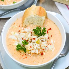 two bowls of soup with bread and garnishes on the top one bowl is filled with cole slaw