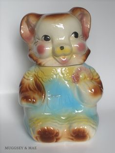 a ceramic bear figurine sitting on top of a table