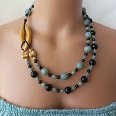 This stunning Jade and Onyx Beaded Statement Necklace is the perfect accessory to elevate any outfit. Handmade with large natural stones, this jewelry piece makes a thoughtful anniversary gift for a loved one or a special treat for yourself. The combination of jade and onyx beads create a beautiful contrast that is sure to turn heads wherever you go. MATERIALS: Our necklace is made of high quality natural Jade and Onyx stones known for their relaxing and balancing properties. Each stone is caref Elegant Onyx Beads For Jewelry Making, Unique Onyx Necklaces For Jewelry Making, Onyx Gemstone Beaded Necklaces For Gifts, Onyx Gemstone Beaded Necklaces As Gift, Onyx Beaded Jewelry For Healing, Onyx Gemstone Beaded Necklace For Gift, Onyx Gemstone Beaded Necklace As A Gift, Handmade Bohemian Onyx Beaded Necklace, Handmade Onyx Beaded Necklaces With Round Beads