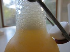 a bottle filled with liquid sitting on top of a table