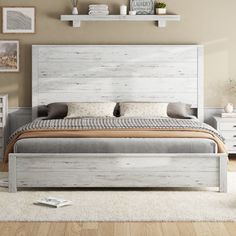 a white bed sitting on top of a wooden floor