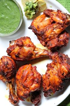 chicken wings on a plate with dipping sauce