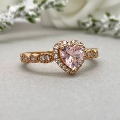 This beautiful ring is made from genuine 925 sterling silver with rose gold plating. Ring details- -The Main stone is a heart shape 6mm High Quality Lab Created Pink Morganite Stone -Side stones are round 1.5mm and 1.1mm simulated diamonds -Ring is casted in solid 925 sterling silver with rose gold plating (yellow gold and rhodium plated also available, please check the drop down menu for more options) -The Total face height of the ring measures 8mms and the band width measures 2mms -Each ring i Heart Wedding Rings, Gold Heart Ring, Simulated Diamond Rings, Heart Engagement Rings, Ring Halo, Heart Shaped Rings, Rose Gold Heart, Dope Jewelry