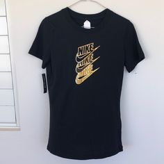 Nike Color Black With Gold Logo Tshirt Size Xtra Small Woman Nike Short Sleeve Top With Text Print, Sporty Black Tops With Logo, Black Logo Top With Short Sleeves, Black Short Sleeve Tops With Logo, Nike Text Print Top For Streetwear, Nike Streetwear Top With Text Print, Nike Tops With Text Print For Streetwear, Trendy Black T-shirt With Logo, Trendy Nike T-shirt With Letter Print