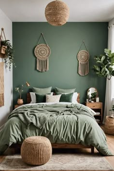 a bed with green sheets and pillows in a bedroom next to potted plants on the wall