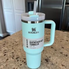 a blue tumbler cup sitting on top of a counter