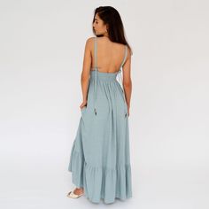 Long, Sage-Colored Maxi Dress with a Fitted Top and Flared Bottom. Made from a blend of linen and viscose – a comfortable, high-quality material. Adjustable string straps with decorative gold ends allow you to tie them in various ways, creating different versions of the dress – halter neck, classic straight straps, or cross-tied. A deep V-neck adds a sensual and very feminine touch. The waistline is finished with an elastic band at the back, which comfortably fits any body shape and accentuates Linen Maxi Dress With Smocked Back And Fitted Style, Fitted Linen Maxi Dress With Smocked Back, Bohemian Tie-back Maxi Dress For Daywear, Bohemian Tie Back Maxi Dress For Daywear, Bohemian Maxi Dress With Tie Back For Daywear, Linen Maxi Dress With Smocked Back, Flowy Linen Dresses, Unlined, Flowy Linen Dresses Unlined, Fitted Linen Maxi Dress With Tie Back