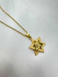 Highly dipped in 18k gold, this necklace features a three-dimensional Star of David pendant that combines tradition with modernity. The pendant has a subtle presence and is paired with a matching gold chain, ensuring it sits comfortably at a standard length. Product Highlights: Material: Dipped in 18k Gold Pendant: 17 mm (0.67 inch) x 19.5 mm (0.77 inch) Chain: 50 cm (20 inches) Closure: Spring ring clasp This necklace is versatile enough for everyday wear and special occasions alike. 3 Layer Necklace, Star Of David Pendant, Layer Necklace, Gold Dipped, Star Of David, Gold Star, 3 Layers, Gold Stars, Spring Rings