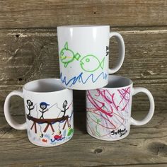 three coffee mugs with different designs on them