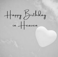 a heart - shaped balloon floating in the air with words happy birthday in heaven written on it