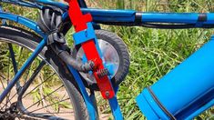 a close up of the front wheel of a bicycle with red and blue spokes