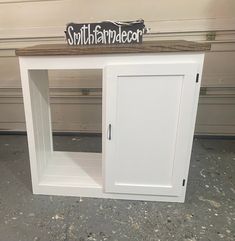 a white cabinet with a sign on top