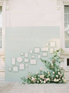 flowers are arranged on the side of a building