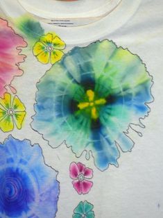 a t - shirt with flowers painted on it