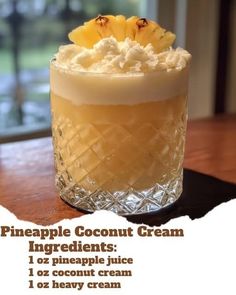 a pineapple coconut cream cocktail with whipped cream on top and an ingredient for the drink