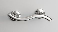 a chrome door handle on a white wall