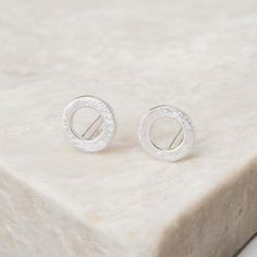 These stunning silver open karma circle studs are perfect for all ages. Symbolising the circle of life, these modern, minimalistic earrings make a memorable gift. Not to be found anywhere on the high street, our beautiful karma circle studs are crafted from the finest sterling silver. Featuring a gorgeous textured finish, these dainty silver open-circle earrings feature a classic butterfly and post fastening and are suitable for almost any age.  Make your earrings even more special by choosing o Court Message, Minimalistic Earrings, The Circle Of Life, Circle Stud Earrings, Bespoke Gifts, Circle Earrings Studs, Circle Studs, Circle Of Life, The Circle