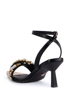 The AZALEA WANG Lethe Black Gem Embellished Sandal features a faux leather upper, a slim stiletto kitten heel, an open pointed toe silhouette, a reflective faux gold instep, faux gold hardware, and a rhinestone-embellished toe bad, Complete with an adjustable ankle strap with a buckle closure. (all measurements are approximate from size 7.5) - 43” Heel Height - Faux Leather Upper - Open Pointed Toe - Stiletto Heel - Imported Product ID: 395737 Black Gems, Azalea Wang, Embellished Sandals, Kitten Heel, Stiletto Heel, Gold Hardware, Ankle Strap, Stiletto Heels, Kitten Heels