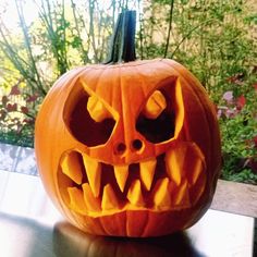 a carved pumpkin with teeth on it's face