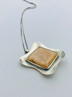 { d e s c r i p t i o n } Modernist silver pendant / brooch with stone , 1956, Made in Finland Design year: 1956 Material: Sterling Silver, stone Marks: PLP makers mark, Crown in heart ( Finland ), 813 ( Silver ), Helsinki city mark, C7 ( Made in 1956 ),  Size: Pendant: About 5.8 cm (About 2.28 inch) The length of the chain: 41 cm ( About 16.14 inches ) Very good vintage condition, ready to wear. There are light signs of use. Please check the pictures. { shipping } I always ship within 3-5 busin Sterling Silver Square Pendant With Natural Stones, Modern Sterling Silver Jewelry With Large Stone, Elegant Silver Necklace With Large Stone, Elegant Rectangular Pendant With Large Stone, Antique Silver Jewelry With Natural Stones, Modernist Gemstone Jewelry For Gifts, Modern Silver Jewelry With Large Stone, Formal Pendant Jewelry With Large Stone, Modernist Sterling Silver Jewelry Gift