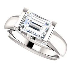 a white gold ring with an emerald cut diamond