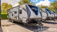 three travel trailers parked in a parking lot with trees and bushes behind them on a sunny day