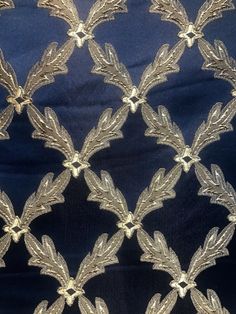 an embroidered fabric with gold leaves on it