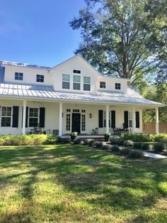 a white house with black shutters on the front