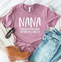 Personalized Nana T-shirt With Grandkids Names Nana Shirt - Etsy Nana Shirt With Grandkids Names, Nana T Shirt Ideas, Casual Unisex T-shirt For Family, Family Graphic Tee With Name Print, Casual Family T-shirt With Name Print, Pre-shrunk Crew Neck T-shirt For Family, Family Matching Soft-washed Short Sleeve T-shirt, Basic Cotton T-shirt For Family Occasions, Unisex Family T-shirt With Name Print