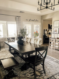 a dining room table with chairs and benches