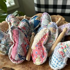 several cloth umbrellas sitting on top of a wooden table