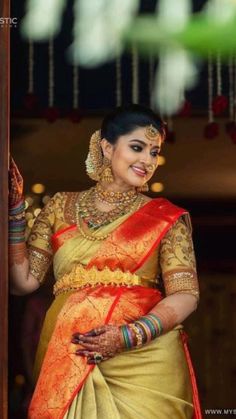 a woman in an orange and yellow sari