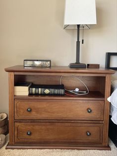 a lamp on top of a wooden dresser