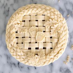 a close up of a pie on a marble surface with other food items around it