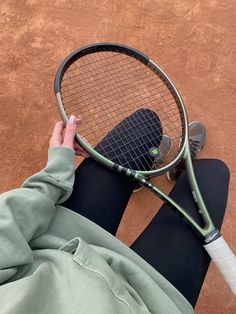 a person holding a tennis racket in their hand