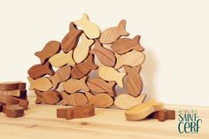 a pile of wooden hearts sitting on top of a table next to some pieces of wood