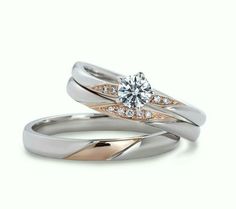 two wedding rings, one with a diamond and the other with an engagement ring on top