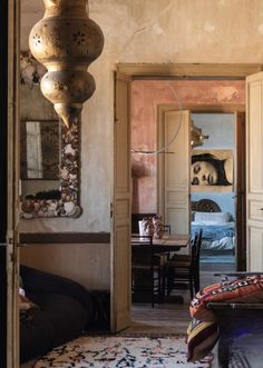 a room with a rug, table and mirror on the wall in front of it