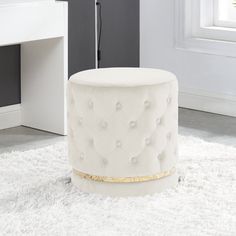 a white ottoman sitting on top of a rug