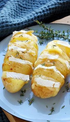 baked potatoes with cream cheese and herbs on a plate