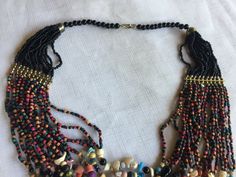 "Multi-color bead statement necklace with a tribal African flair. Lots of different shapes and colors, including a few tiny shells. About 18\" long, hangs about 4\" deep on your chest. Also, please take a look at my storefront at: https://www.etsy.com/shop/FabFinds42?ref=seller-platform-mcnav I have a wide selection of one-of-a-kind items, from clothing and toys to home decor and gift items, and I add new things almost every day." Tiny Shells, Africa Necklace, Multi Coloured Necklaces, Orange Bracelet, Necklace Bead, Retro Clock, Coral Bracelet, Beaded Statement Necklace, Multi Strand Necklace